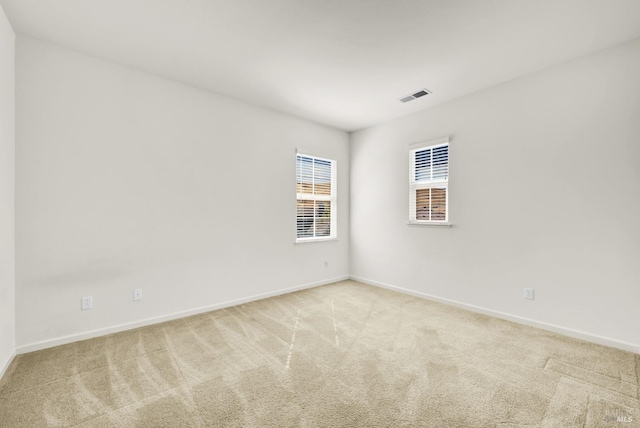 empty room featuring light colored carpet