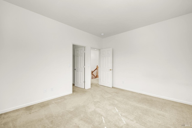 unfurnished bedroom featuring light carpet