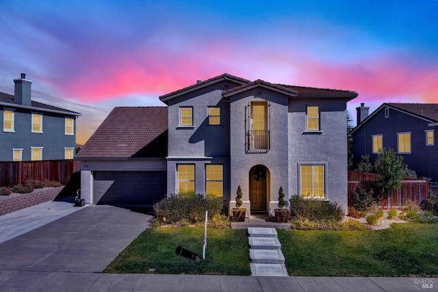 view of front of home with a yard and a garage