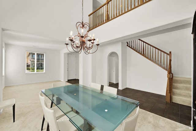 carpeted dining space featuring an inviting chandelier