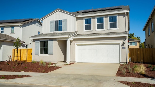 view of front of home featuring a garage and solar panels