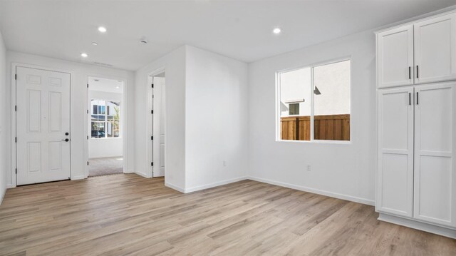 spare room with light hardwood / wood-style floors