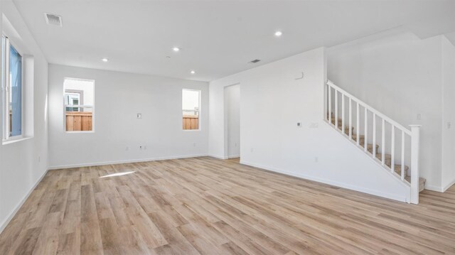 unfurnished living room with light hardwood / wood-style flooring