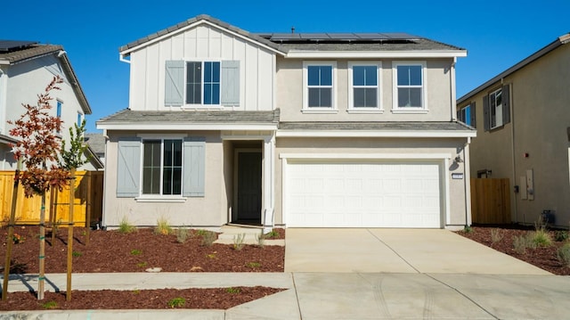 view of front of property featuring a garage and solar panels