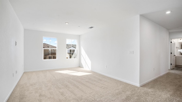 unfurnished room with light colored carpet