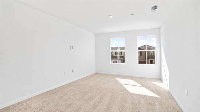 spare room with light colored carpet