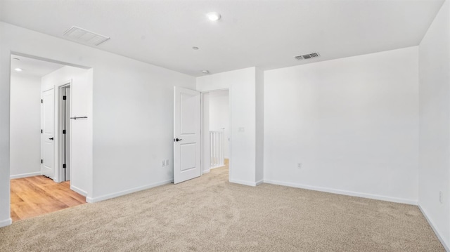 unfurnished bedroom featuring light carpet