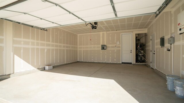 garage with a garage door opener and electric panel