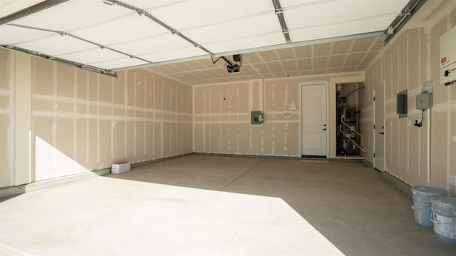 garage featuring a garage door opener and electric panel