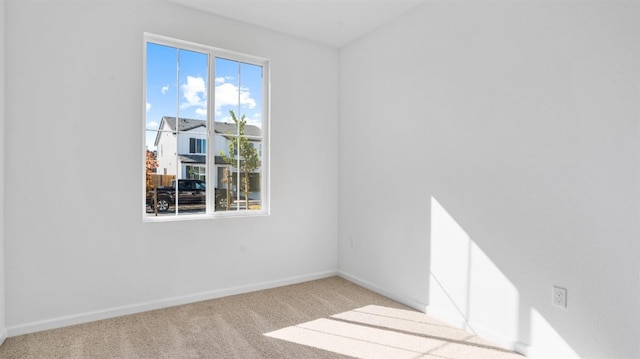 unfurnished room with light carpet