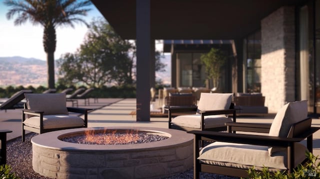 view of patio featuring an outdoor living space with a fire pit