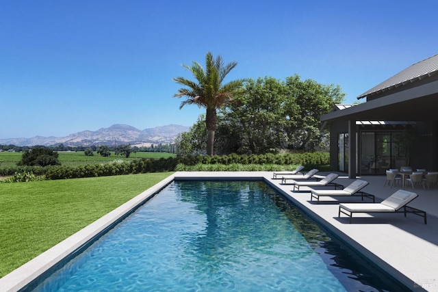 view of pool featuring a mountain view, a patio area, and a lawn