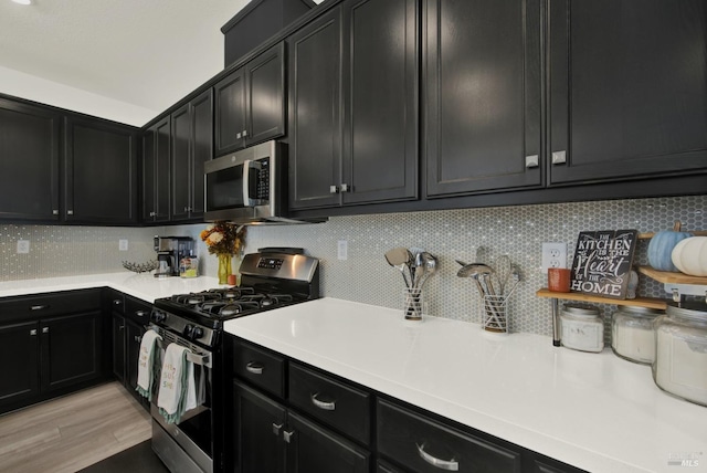 kitchen with stainless steel appliances, backsplash, and light hardwood / wood-style floors