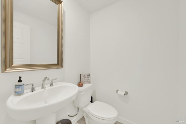 bathroom featuring toilet and sink