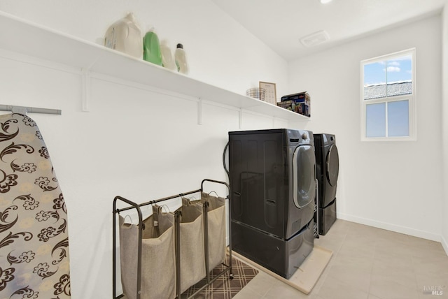 clothes washing area featuring independent washer and dryer and tile patterned floors