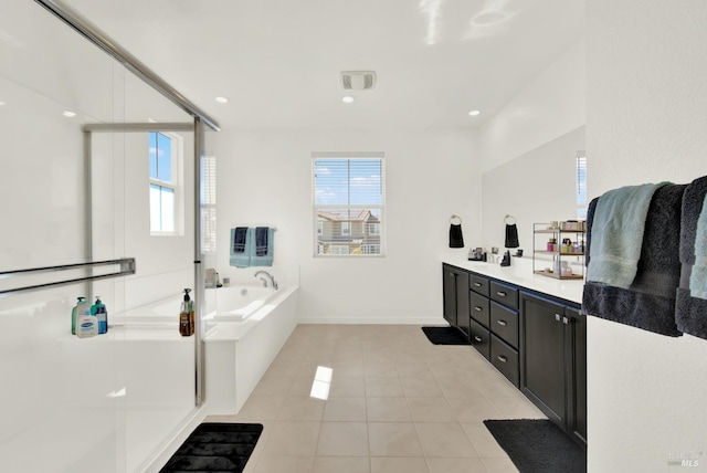 bathroom with vanity, a healthy amount of sunlight, plus walk in shower, and tile patterned flooring