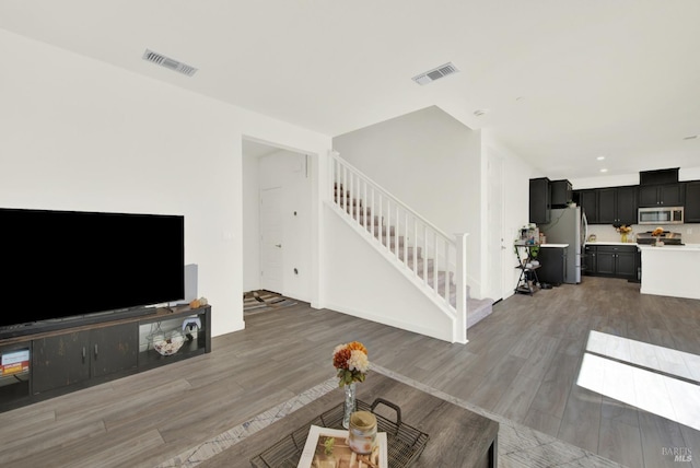 2464 Lake Club Dr, Fairfield, CA 94533 - living room featuring light wood finished floors, visible vents, recessed lighting, and stairway