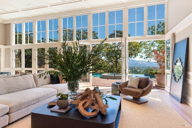 living room with light hardwood / wood-style flooring, a wealth of natural light, and a mountain view