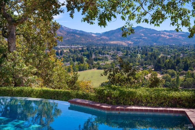 view of swimming pool with a mountain view