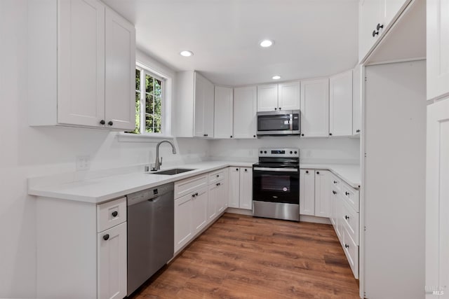 kitchen featuring white cabinetry, sink, dark hardwood / wood-style flooring, and appliances with stainless steel finishes