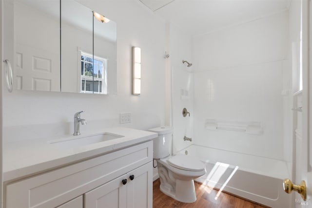 full bathroom with shower / washtub combination, hardwood / wood-style floors, vanity, and toilet