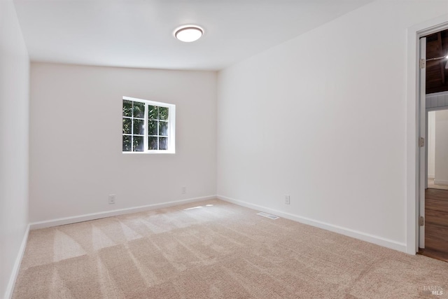 empty room with light colored carpet