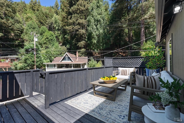 wooden terrace with an outdoor hangout area