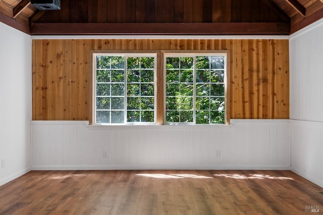 spare room with vaulted ceiling, wooden ceiling, and wood-type flooring