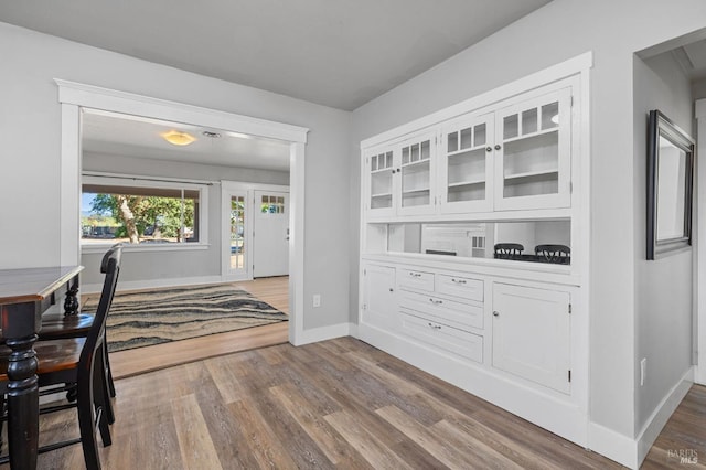 interior space with baseboards and wood finished floors