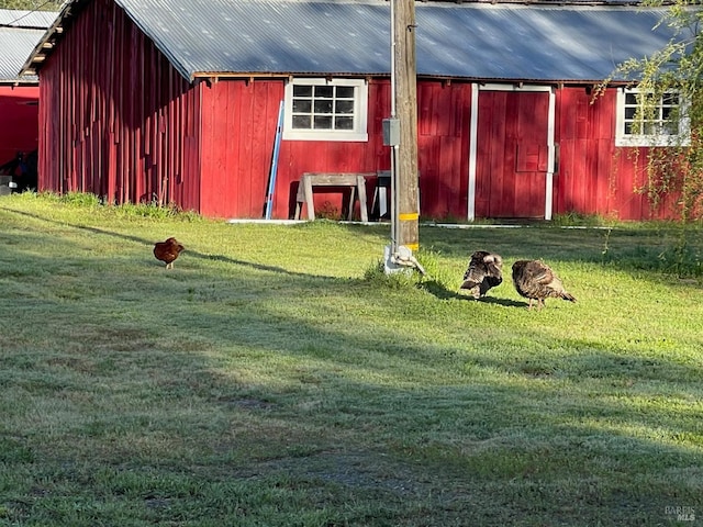 view of pole building with a lawn
