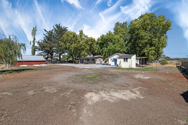 view of yard featuring an outdoor structure and fence