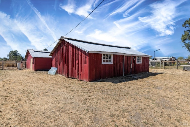 view of outbuilding with an outbuilding and fence
