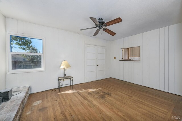 unfurnished room with hardwood / wood-style floors and ceiling fan