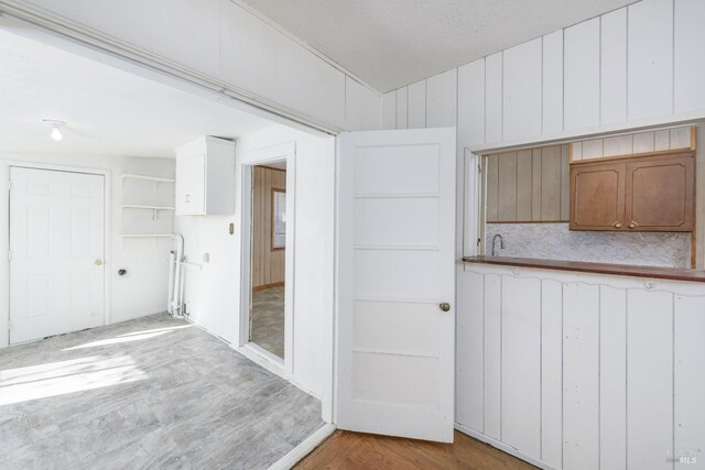 interior space with vaulted ceiling and light hardwood / wood-style flooring