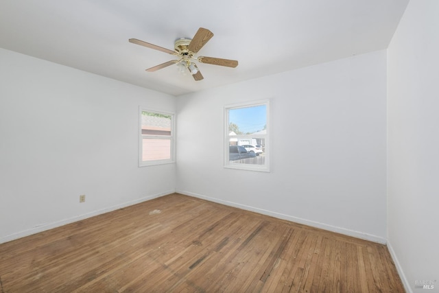 spare room featuring wood-type flooring and ceiling fan