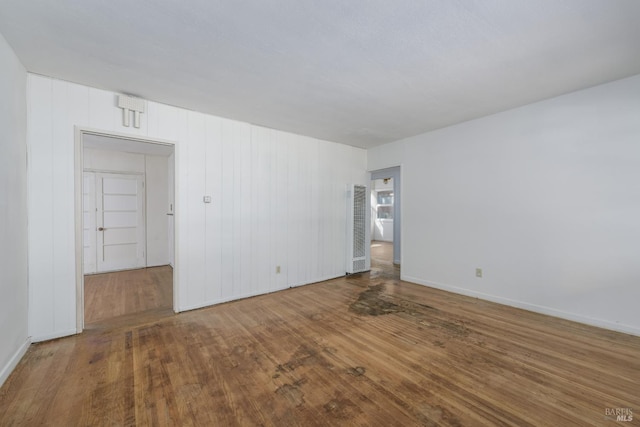 spare room with wood-type flooring