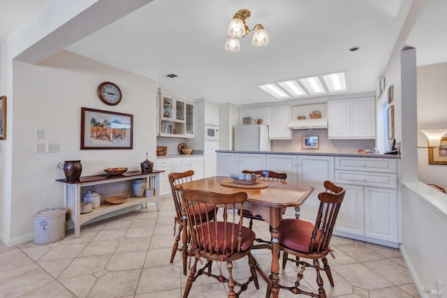 dining room with an inviting chandelier and light tile patterned floors