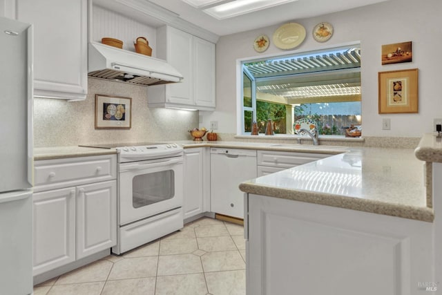 kitchen featuring white appliances, light tile patterned floors, ventilation hood, and white cabinets