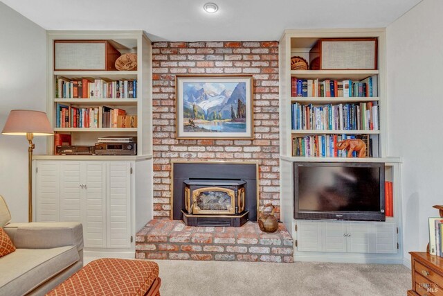 living area with light carpet and a wood stove