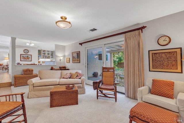 living room with light carpet and decorative columns