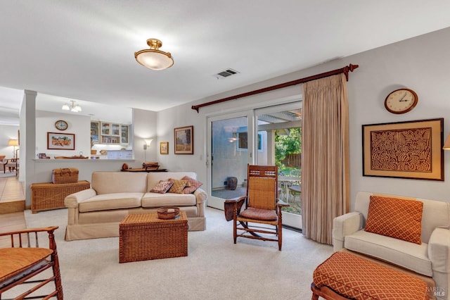 living room with light carpet and ornate columns