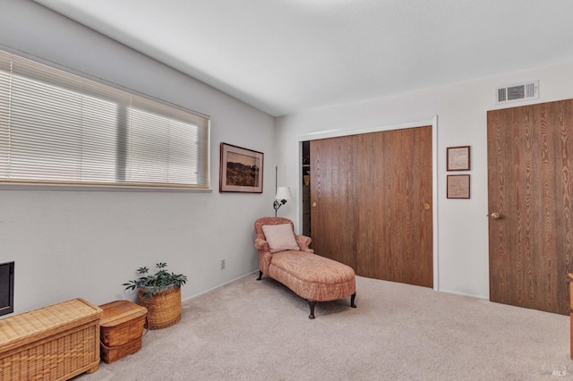 living area with light carpet