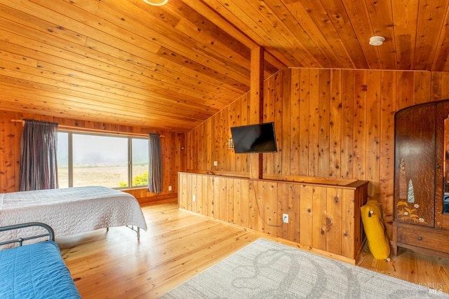 bedroom featuring lofted ceiling, wooden walls, hardwood / wood-style flooring, and wood ceiling