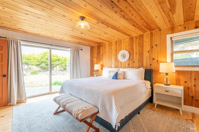 bedroom featuring light wood-type flooring, wood walls, access to exterior, and wooden ceiling