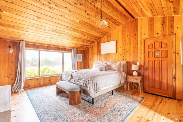 bedroom with wood walls, light wood-type flooring, wooden ceiling, and lofted ceiling with beams