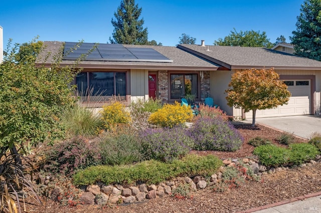 single story home featuring a garage and solar panels