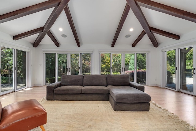 sunroom / solarium featuring vaulted ceiling and french doors