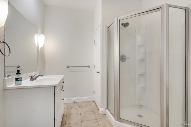 bathroom featuring vanity, an enclosed shower, and tile patterned flooring