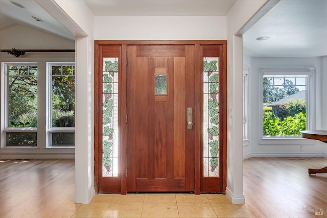 entrance foyer featuring a wealth of natural light and light tile patterned floors