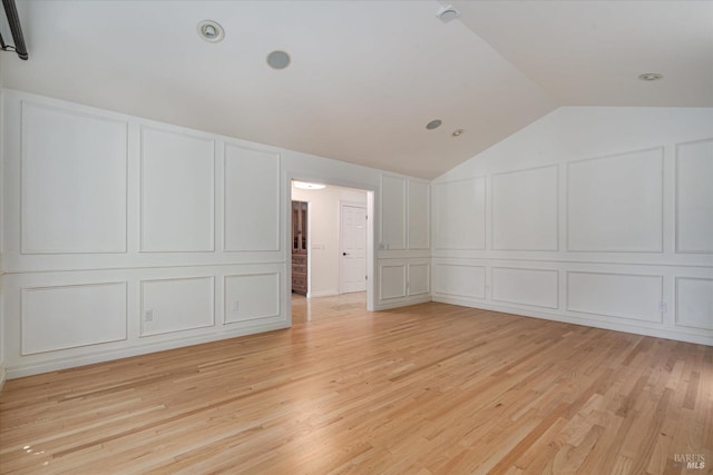 bonus room featuring light hardwood / wood-style flooring and lofted ceiling